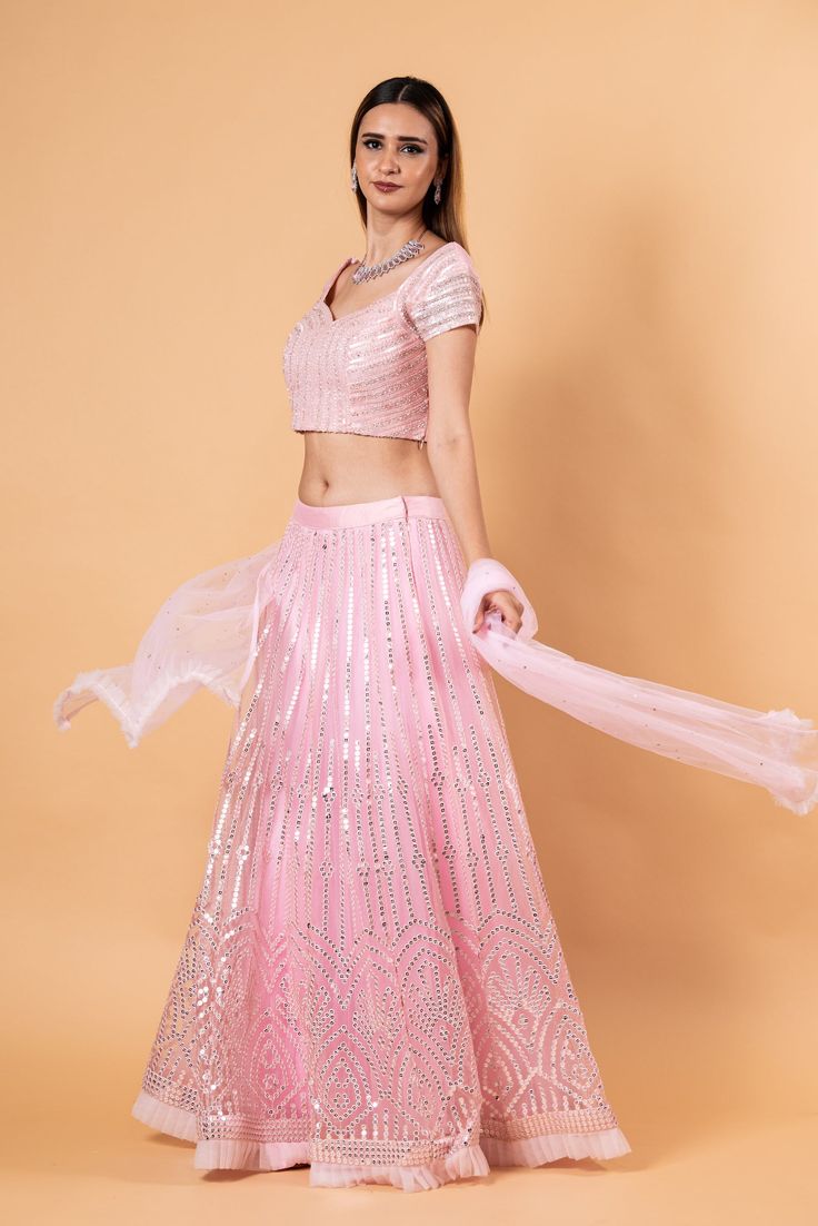 Steal the spotlight with this Pink Net Lehenga Set. this ensemble is intricately embroidered, making it the perfect choice for any occasion. Fitted Embroidered Party Wear Sets, Fitted Organza Sets For Ceremonies, Embroidered Fitted Party Wear Sets, Festive Embroidered Organza Fabric For Ceremony, Party Wear Sets With Resham Embroidery In Art Silk, Fitted Sequin Set For Reception, Organza Embroidered Choli For Ceremony, Organza Sets With Dupatta For Ceremony, Fitted Art Silk Sets With Mirror Work