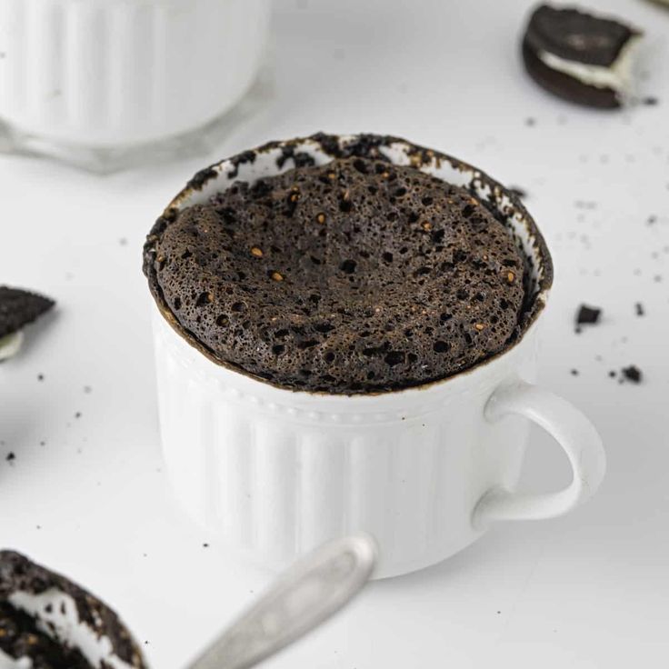 a white cup filled with chocolate cookies and oreos