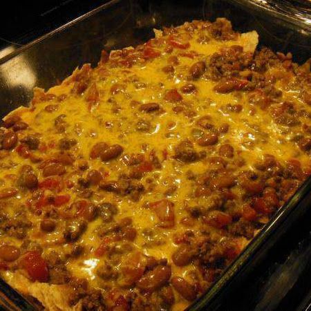 a casserole dish with meat and cheese on it sitting in an oven, ready to be eaten