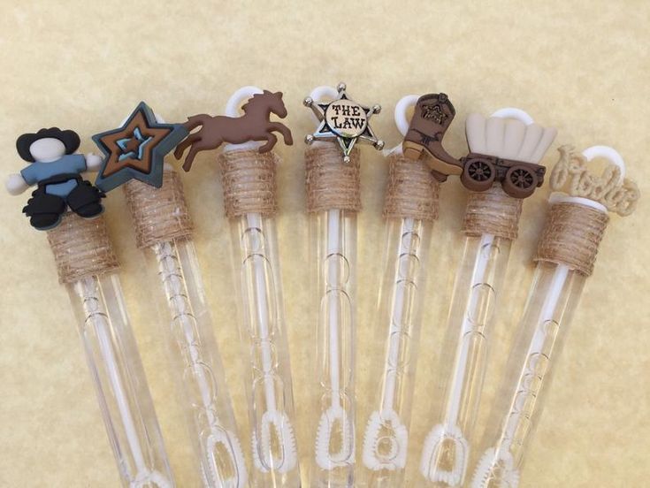 a set of six clear glass toothbrushes decorated with horse and carriage design on them