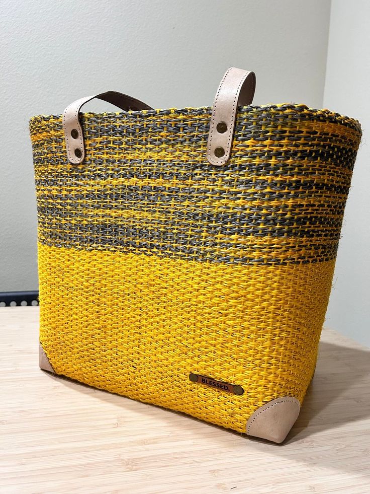 Handmade sisal basket. Perfect for a day at the beach or summer city errands! Casual Yellow Woven Beach Bag, Yellow Handwoven Beach Bag, Casual Yellow Handmade Straw Bag, Weaving Straw Bucket Bag For Market, Handwoven Yellow Straw Beach Bag, Bucket Straw Bag With Weaving For Market, Yellow Handwoven Straw Bag For Summer, Market Bucket Straw Bag With Weaving, Summer Yellow Handwoven Straw Bag