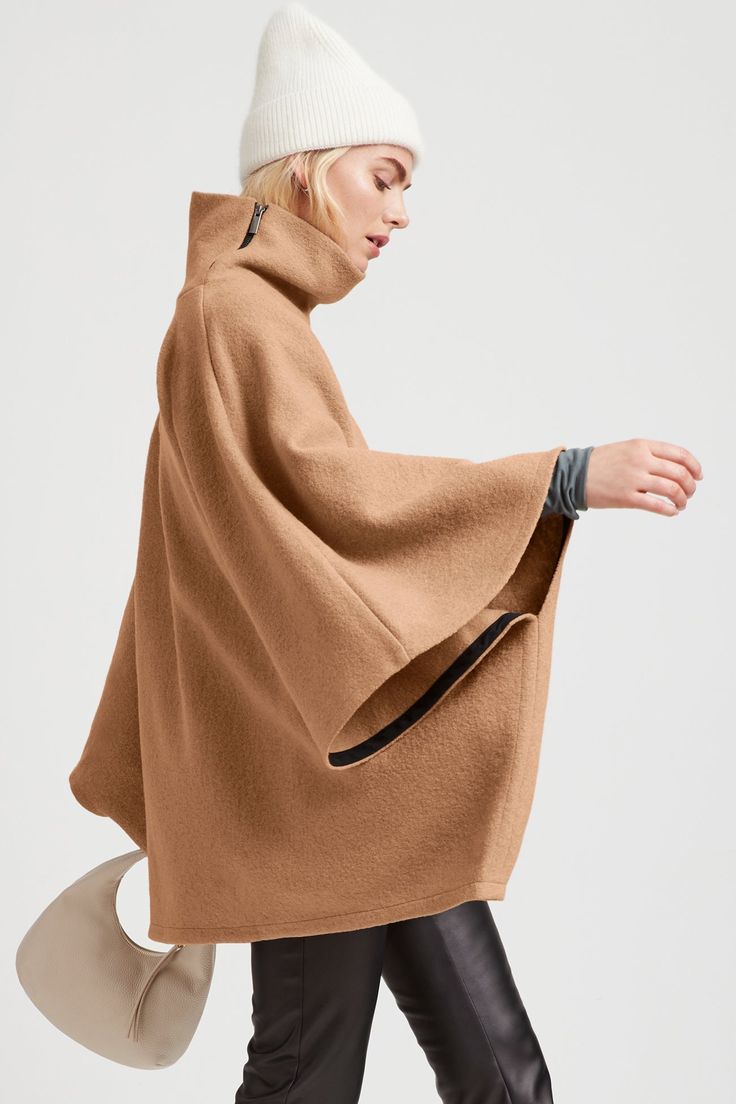 A stylish wool winter cloak, our Avery Cape is the ideal choice for heading out into the cold. Fashioned from Italian virgin wool and offered in fresh neutrals that pair well with any combination of clothing, this women’s wool cape is designed with a loose silhouette. Simple. Elegant. Cozy. Layer her over anything for an instant ready-to-go look. Avery's high collar has a side zipper for style and easy wear. This wool winter cape is lined for added warmth and comfort. | Maritza Long Sleeve Wool Cape For Fall, Wool Outerwear With Funnel Neck For Fall, Chic Funnel Neck Outerwear For Work, Wool Funnel Neck Outerwear For Work, Modern Fall Cape For Workwear, Wool Outerwear With Funnel Neck For Work, Funnel Neck Wool Outerwear For Work, Modern Funnel Neck Winter Outerwear, Modern Winter Outerwear With Funnel Neck