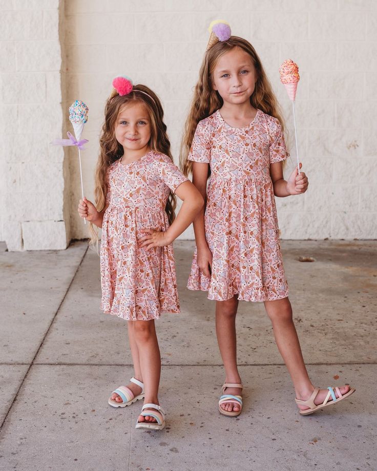 Whip up a swirl of fun with this Scoop There It Is Dream Ruffle Dress! This cute, ice cream themed dress is a perfect way to twirl and show off your style. With its ruffled fabric and short sleeves, you'll be sure to scoop up plenty of compliments! Made from the softest and most breathable seasonal bamboo viscose material, your babe won't want to take this off! Designed for all the love and extra play! All dreamyZzz items are snug fit to meet CPSC compliance Sizes available: 2T, 3T, 4T, 5/6, 7/8 Ruffled Fabric, Cute Ice Cream, Bearer Outfit, Girls Dress Outfits, Bodysuit Dress, Wedding Dress Shoes, Cap Sleeve Top, Birthday Party Dress, Baby Halloween Costumes