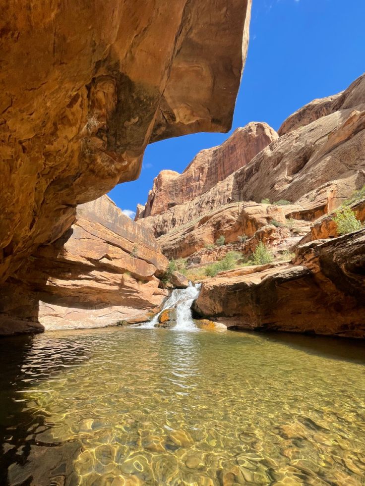 a river running through a canyon next to rocks