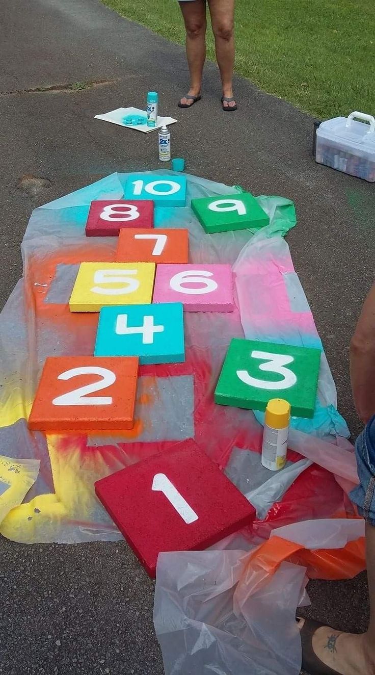 a table that has numbers on it with plastic bags around it and two people standing next to it