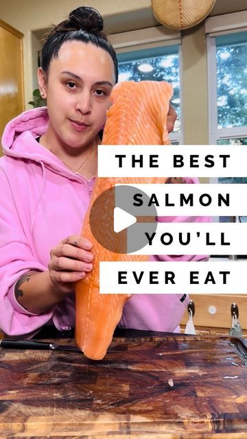 a woman holding up a piece of salmon in front of her face with the words, the best salmon you'll ever eat