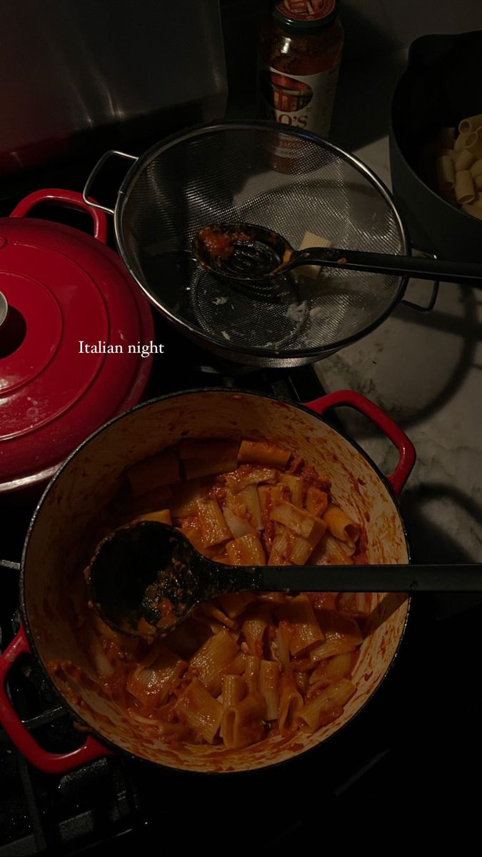 some food is being cooked in a pot on top of the stove with other cooking utensils