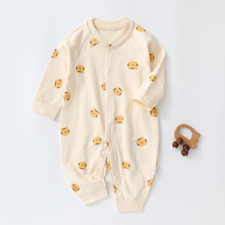 Be the cutest baby around in this Fun and Cozy Cartoon Bear Romper. This romper will keep your baby warm and cozy all day long while bringing a smile to everyone's face with its irresistibly cute design. Get ready to stand out from the crowd! Introducing the Unisex Cartoon Romper, designed for fun and comfort. Made from soft and breathable cotton, it's perfect for spring and autumn wear. Featuring a charming cartoon pattern, this romper adds a touch of cuteness to your baby's wardrobe. Equipped White Long Sleeve Jumpsuits And Rompers For Sleep, Cream Cotton Onesie For Winter, Cute Cartoon Print Jumpsuits And Rompers For Playtime, Winter Cream Cotton Onesie, Playful Cotton Onesie For Sleep, Family Matching Long Sleeve Onesie For Loungewear, Cream Long Sleeve Onesie For Bedtime, Cute Cotton Jumpsuits And Rompers With Long Sleeves, Cute Cotton Jumpsuit With Long Sleeves