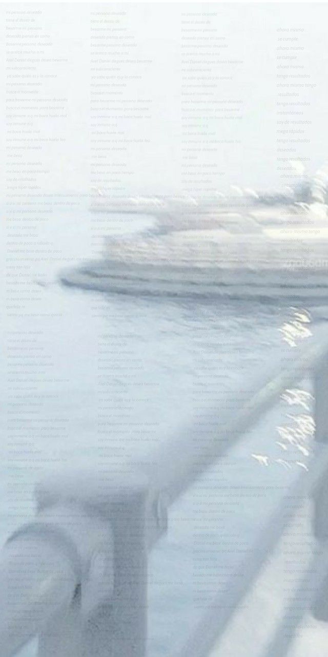 a blurry photo of a boat in the water near a pier with railings