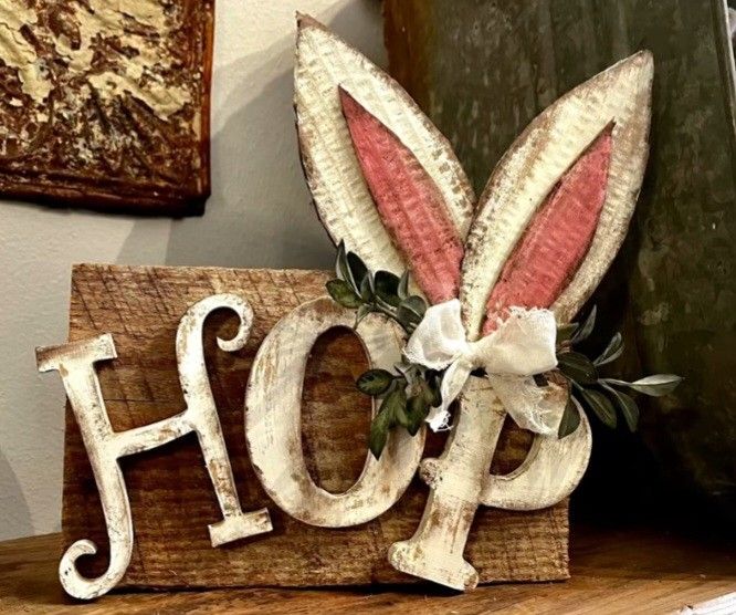 a wooden sign with the word hope painted on it's side and an easter bunny head