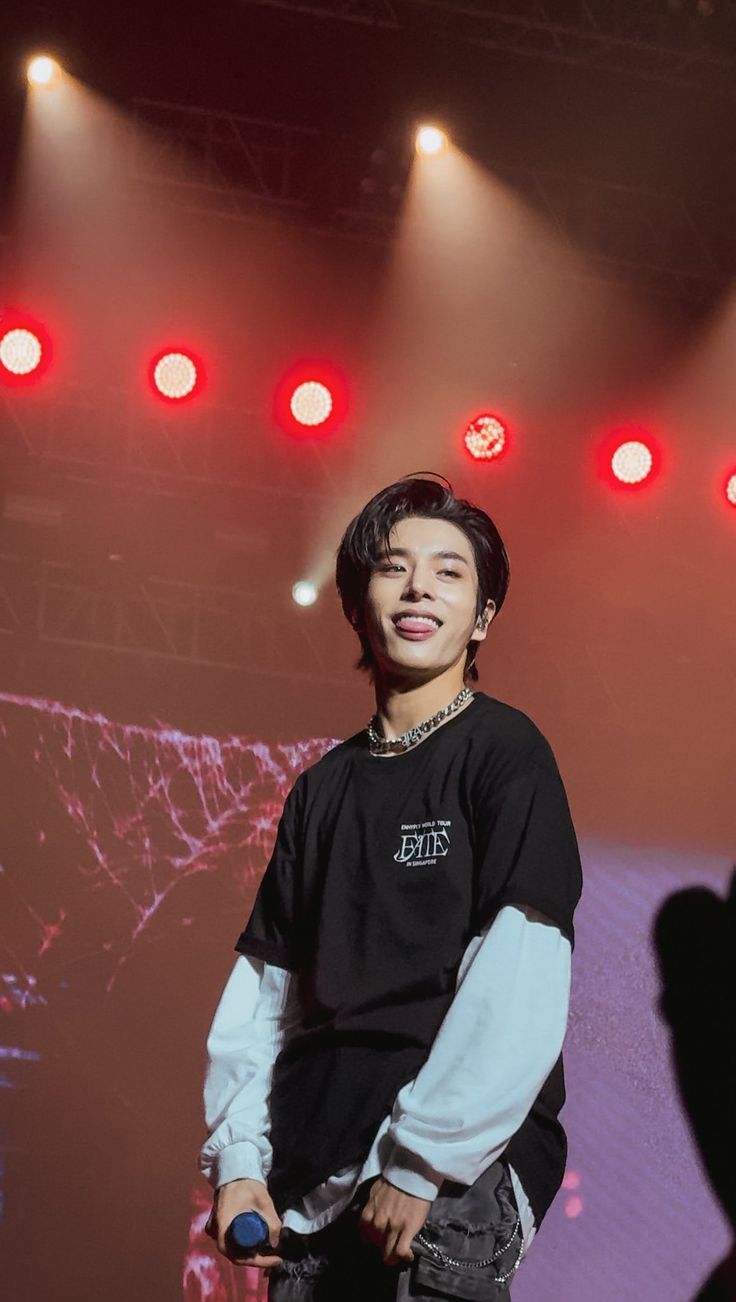 a young man standing on top of a stage