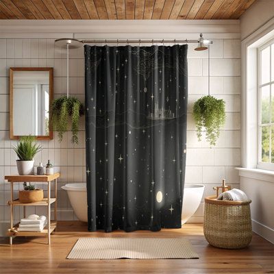 a bathroom that has a shower curtain with stars on it and plants in the window