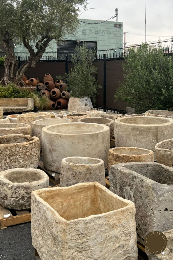 large stone planters sitting in the middle of a parking lot