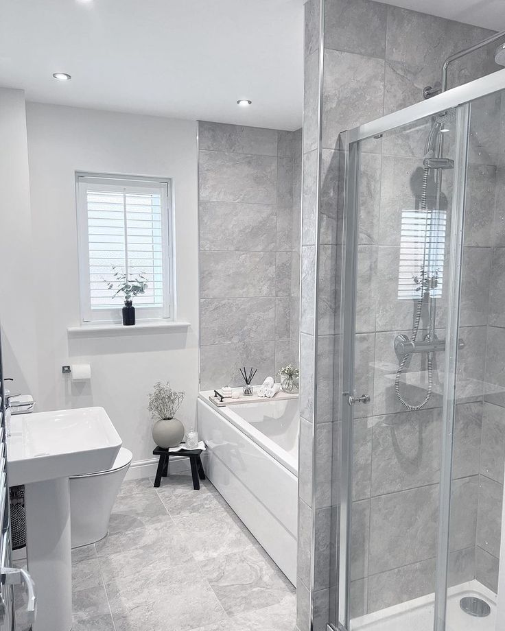 a bathroom with a walk in shower next to a bath tub