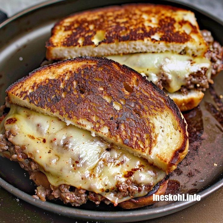 two grilled cheese sandwiches on a plate