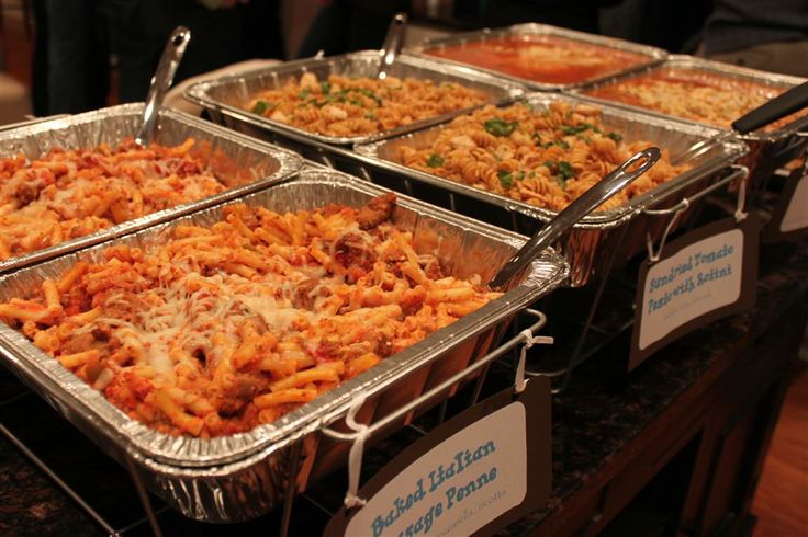 several trays of food sitting on top of a table