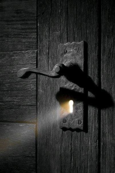 a doorknob with a light shining through it and a keyhole in the middle