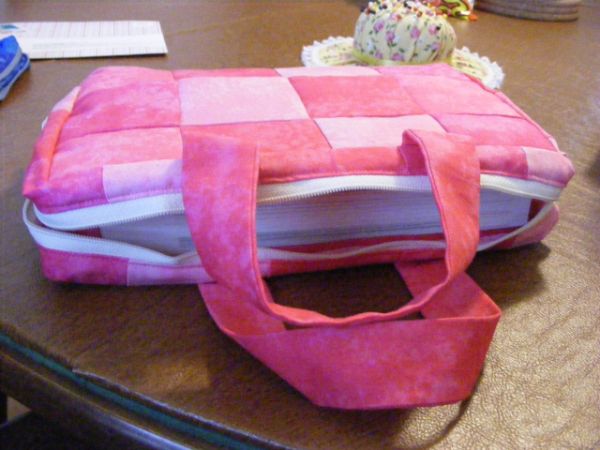 a pink bag sitting on top of a wooden table