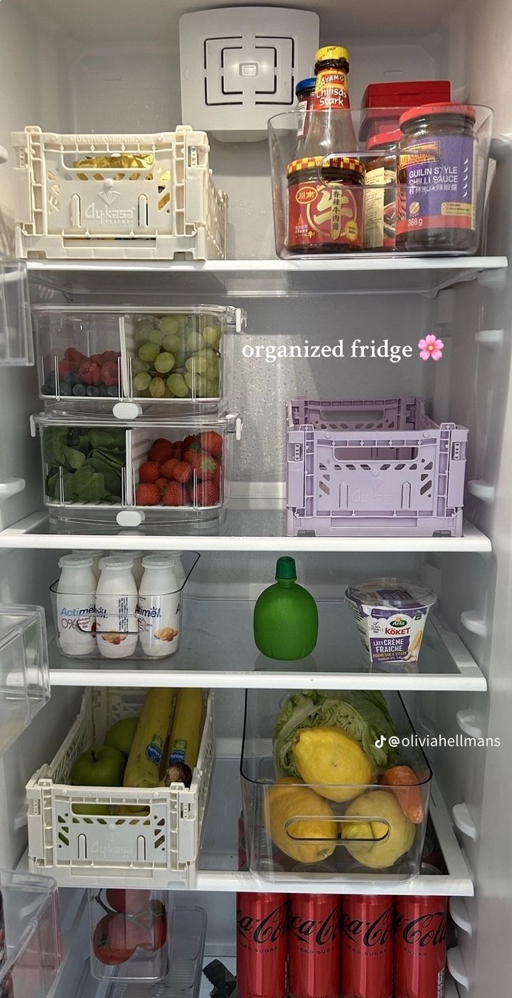 an open refrigerator filled with lots of different types of fruits and vegetables in containers on the shelves