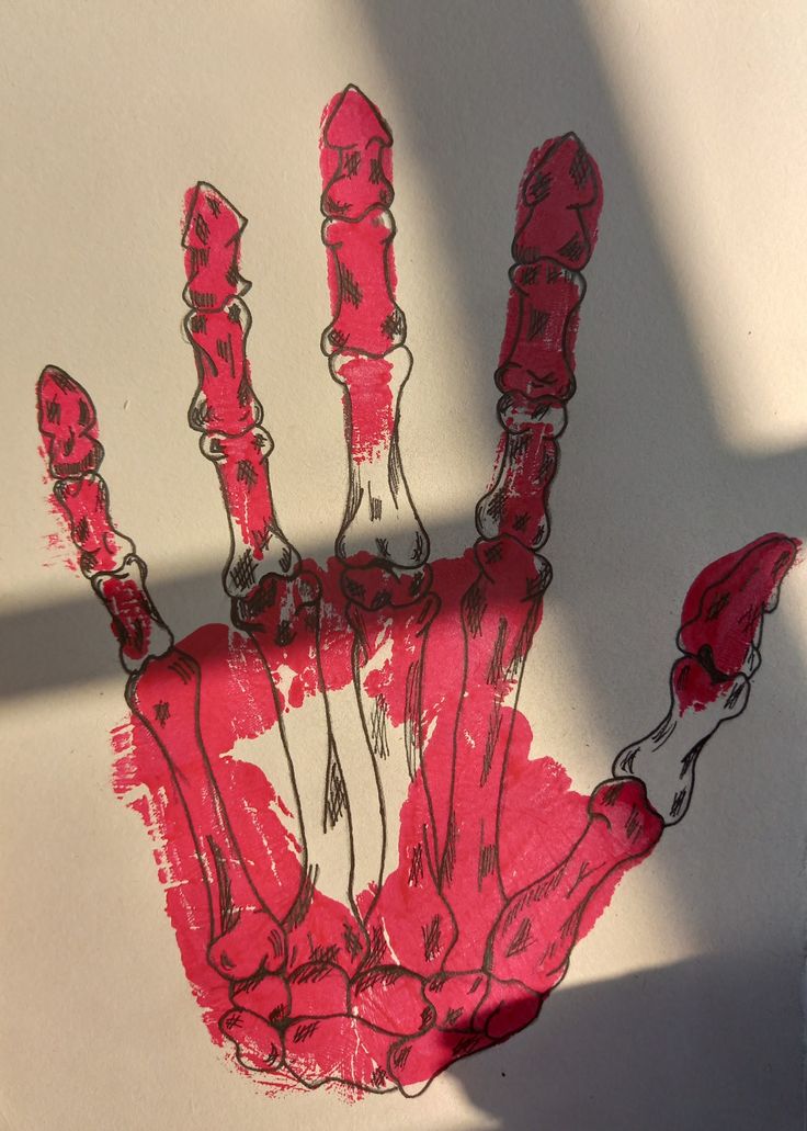 a drawing of a hand is shown with red paint on white paper and the shadow of a person's hand