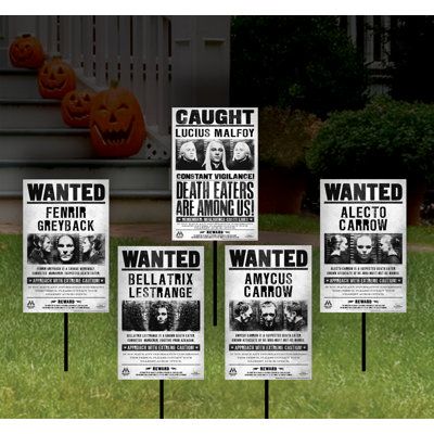 halloween yard signs in front of a house