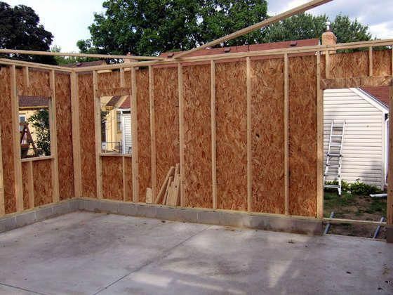 the inside of a house being built with wood framing and walls in place for windows