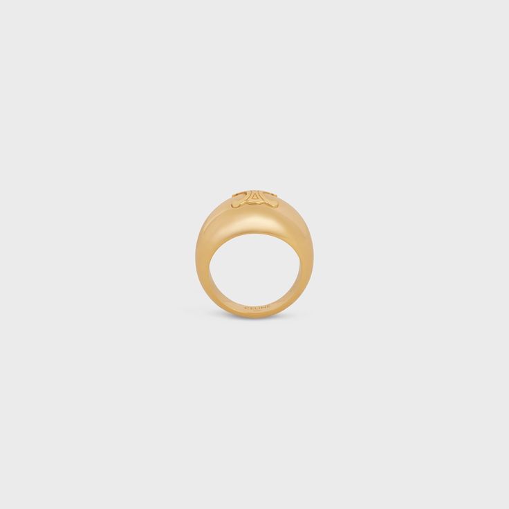 TRIOMPHE BOLD RING IN BRASS WITH GOLD FINISH - GOLD | CELINE Luxury Gold Diamond Ring For Formal Occasions, Fine Jewelry Gold Dome Ring Recycled Material, Timeless Gold Engraved Diamond Ring, Timeless Engraved Gold Diamond Ring, Classic Gold Diamond Ring, Tarnish Resistant, Gold Open Dome Ring In Recycled Gold, Luxury Polished Yellow Gold Dome Ring, Luxury Open Dome Ring For Formal Occasions, Polished Yellow Gold Dome Ring In Recycled Gold