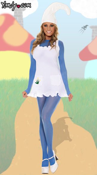 a woman dressed in a costume standing on a dirt road with trees and mushrooms behind her