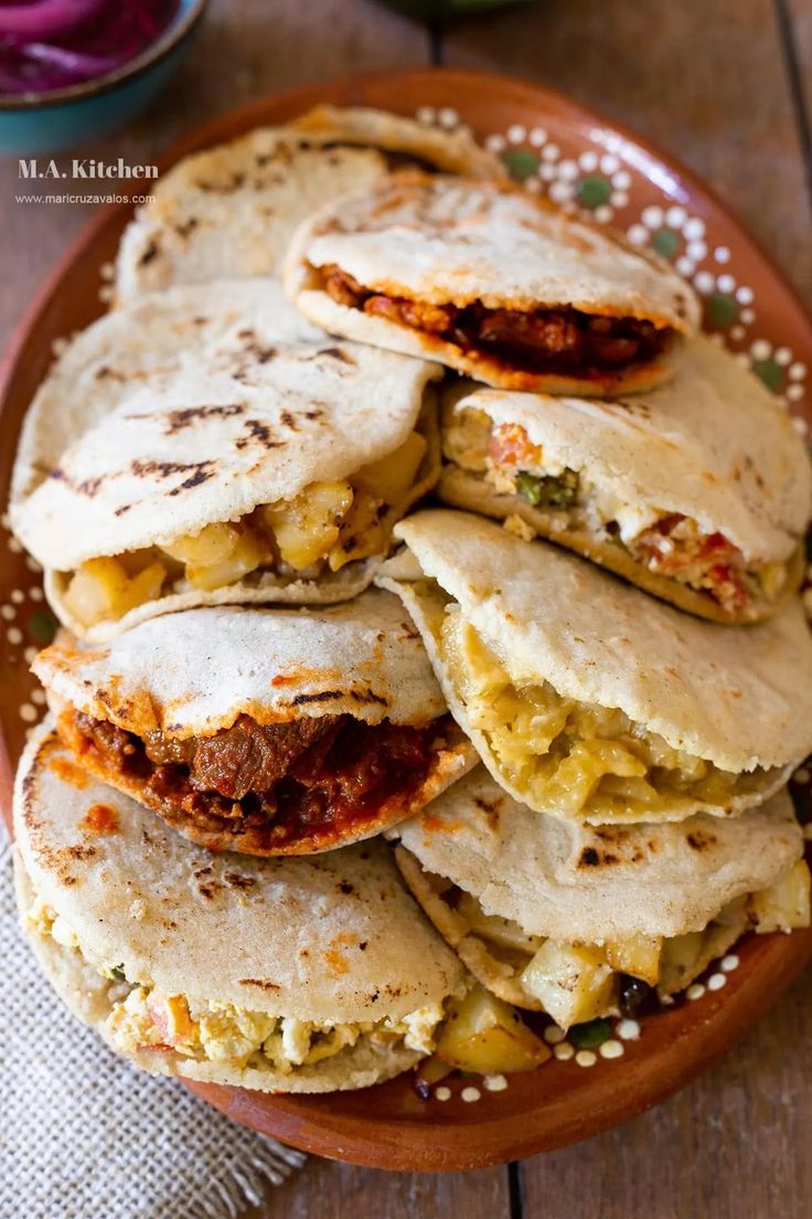 several tortillas stacked on top of each other in a brown plate with white speckles