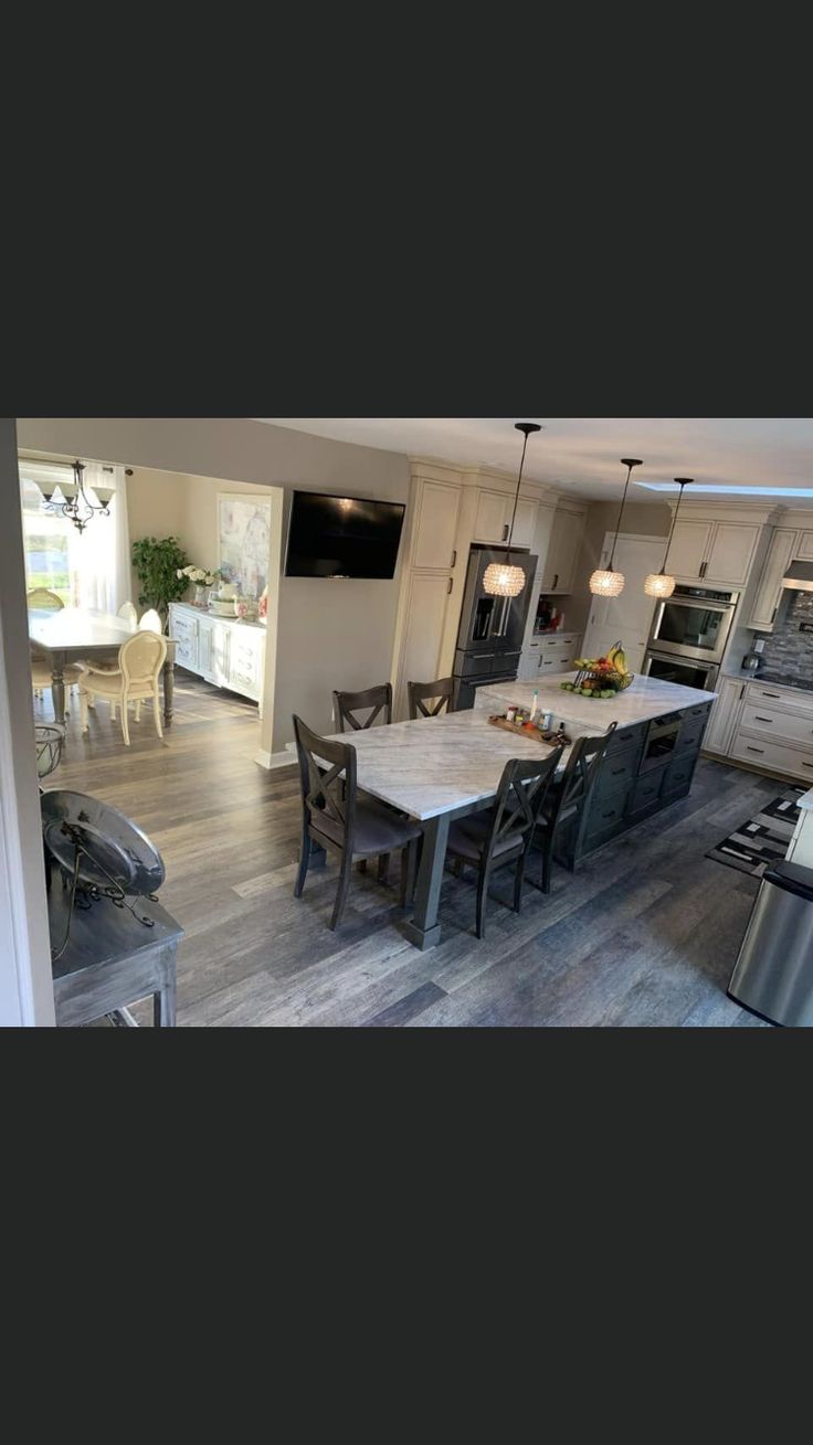 an open kitchen and dining room with wood flooring