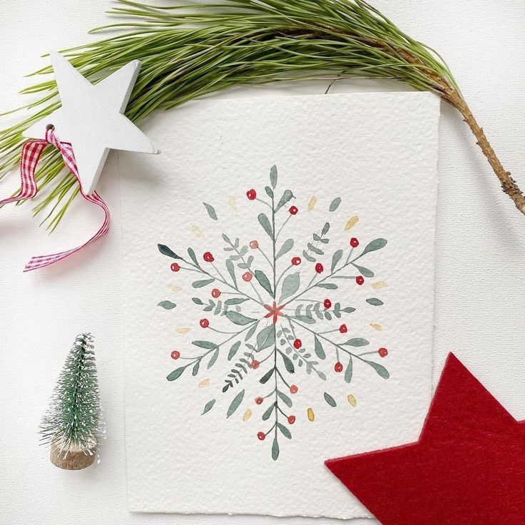 a christmas card with a snowflake on it next to a red star and evergreen tree