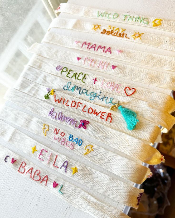 embroidered tea towels with words written on them