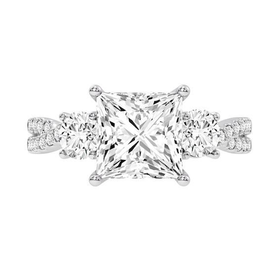 a princess cut diamond ring with three side stones