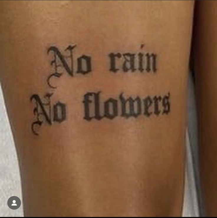 a tattoo saying no rain, no flowers