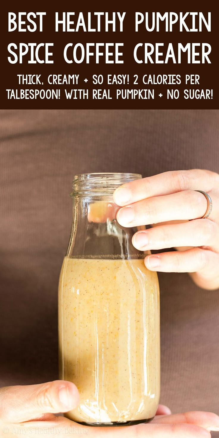 a person holding a glass jar filled with coffee creamer and text overlay reads best healthy pumpkin spice coffee creamer