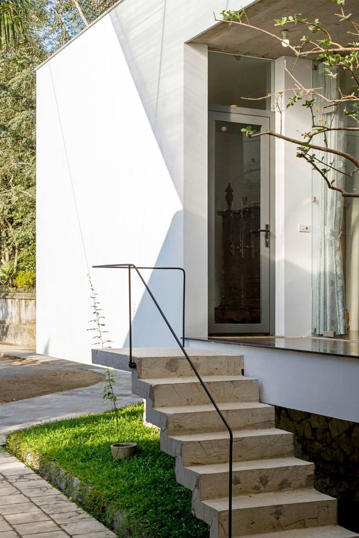 a white house with steps leading up to the front door