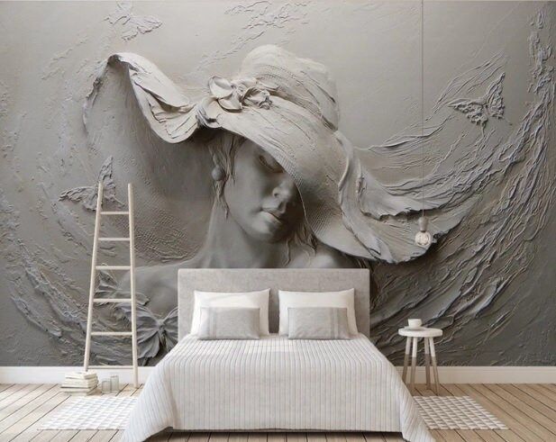 a bedroom with a large wall mural depicting a woman's head in a hat