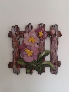 a wooden frame with flowers and leaves on the inside is made out of driftwood