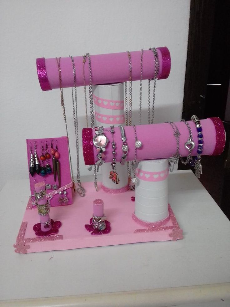 the pink jewelry stand has many necklaces on it