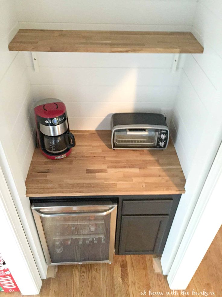 there is a toaster, microwave and toaster on the counter in this kitchen