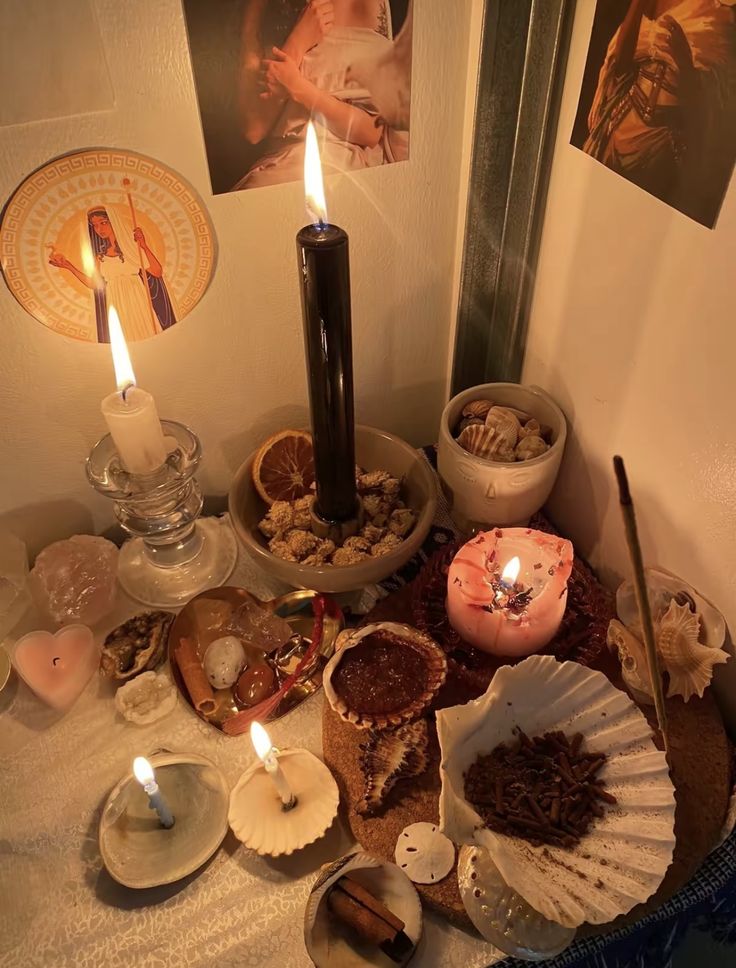 an assortment of seashells and candles on a table