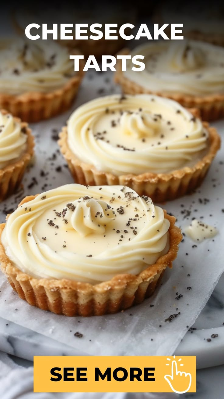 small cheesecake tarts with white frosting and sprinkles on top