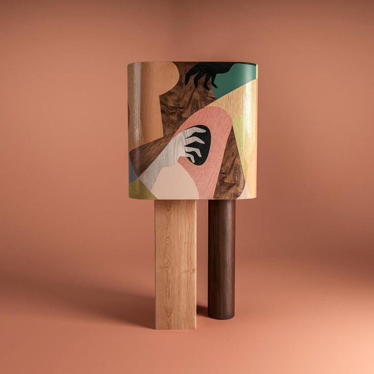 a wooden object with an abstract painting on it's side and a stick sticking out of it