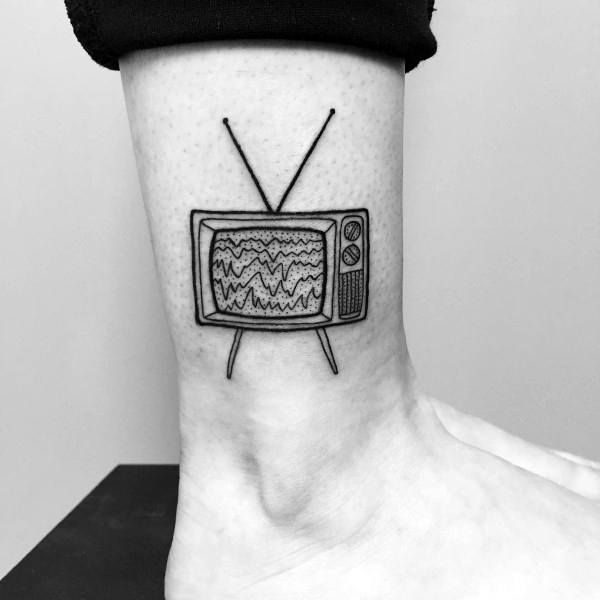 a black and white photo of a tv tattoo