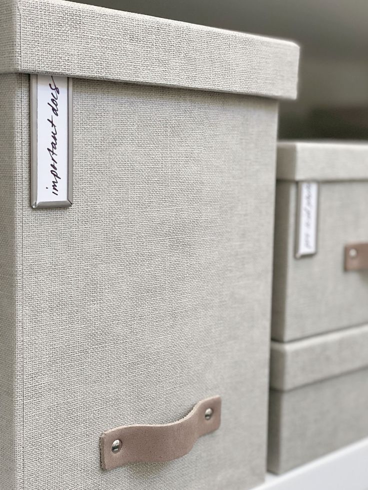 two drawers with labels on them sitting side by side