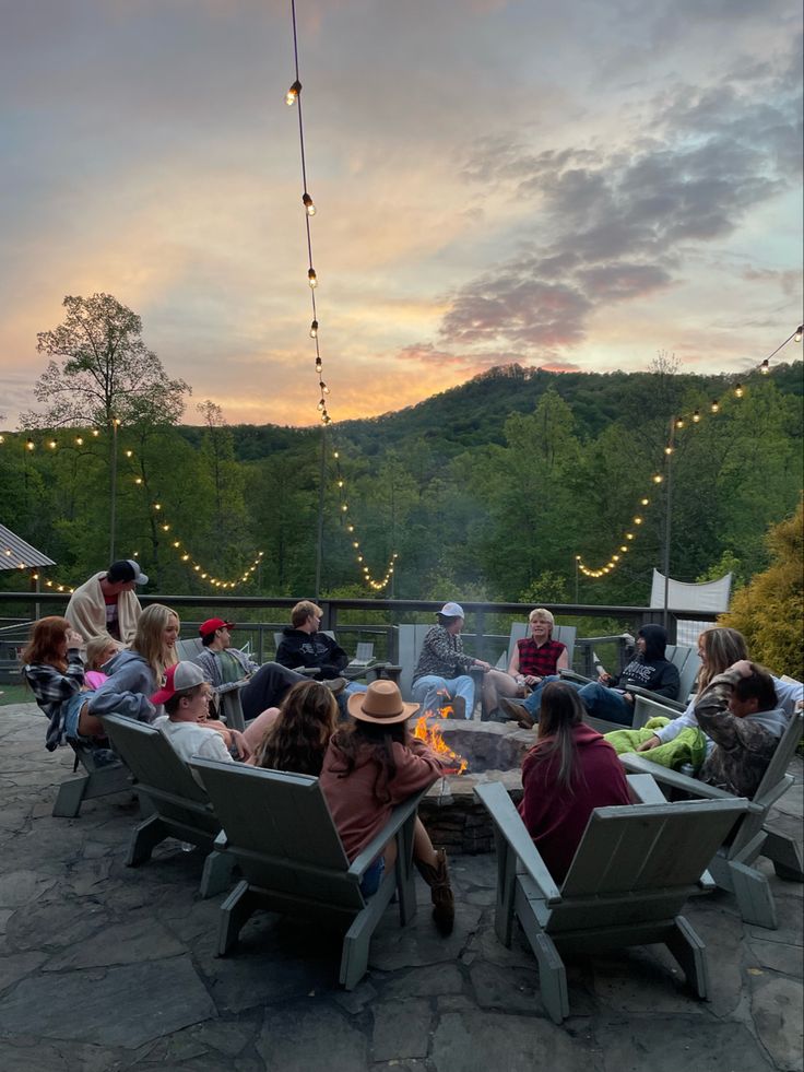 a group of people sitting around a fire pit