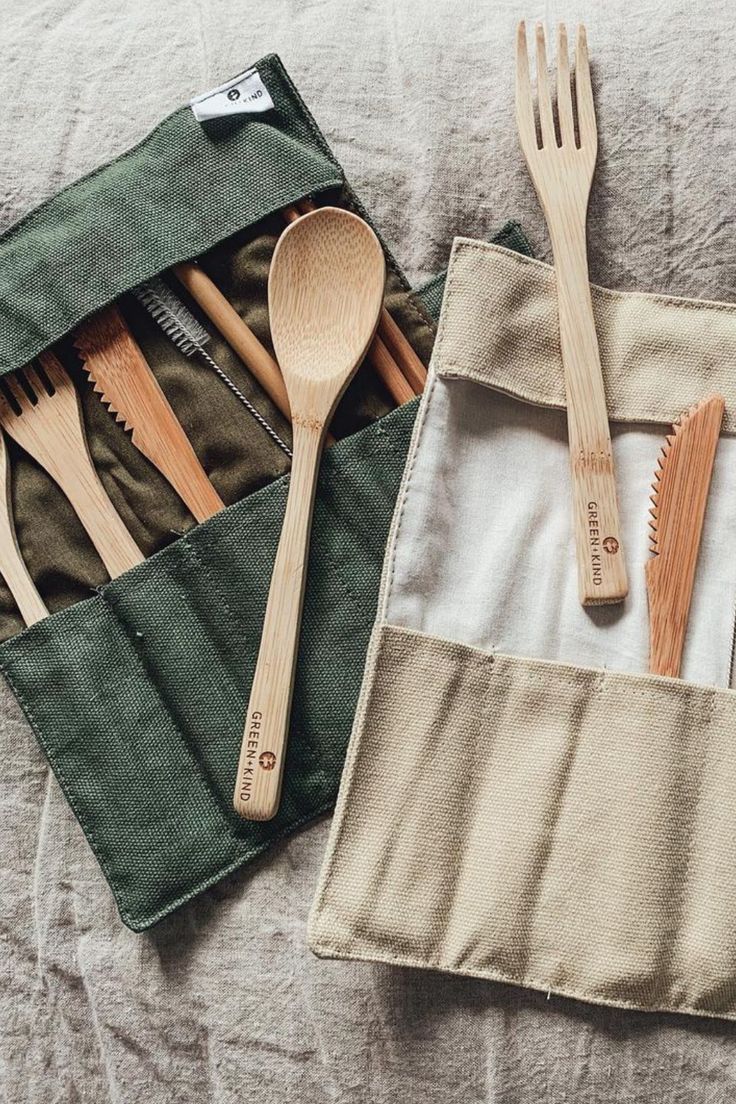 wooden utensils and spoons in a pouch on a bed