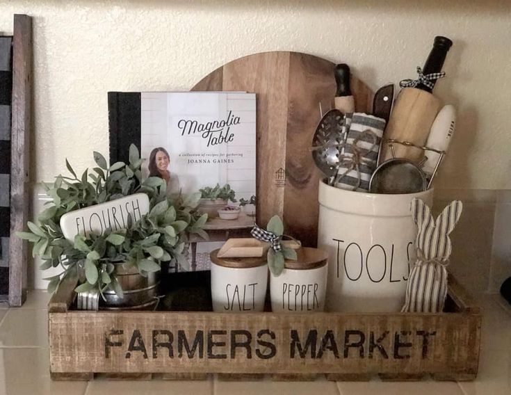 a wooden crate filled with lots of items on top of a counter next to a sign that says farmer's market