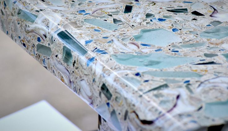 a close up of a table with blue and white tiles on it's surface