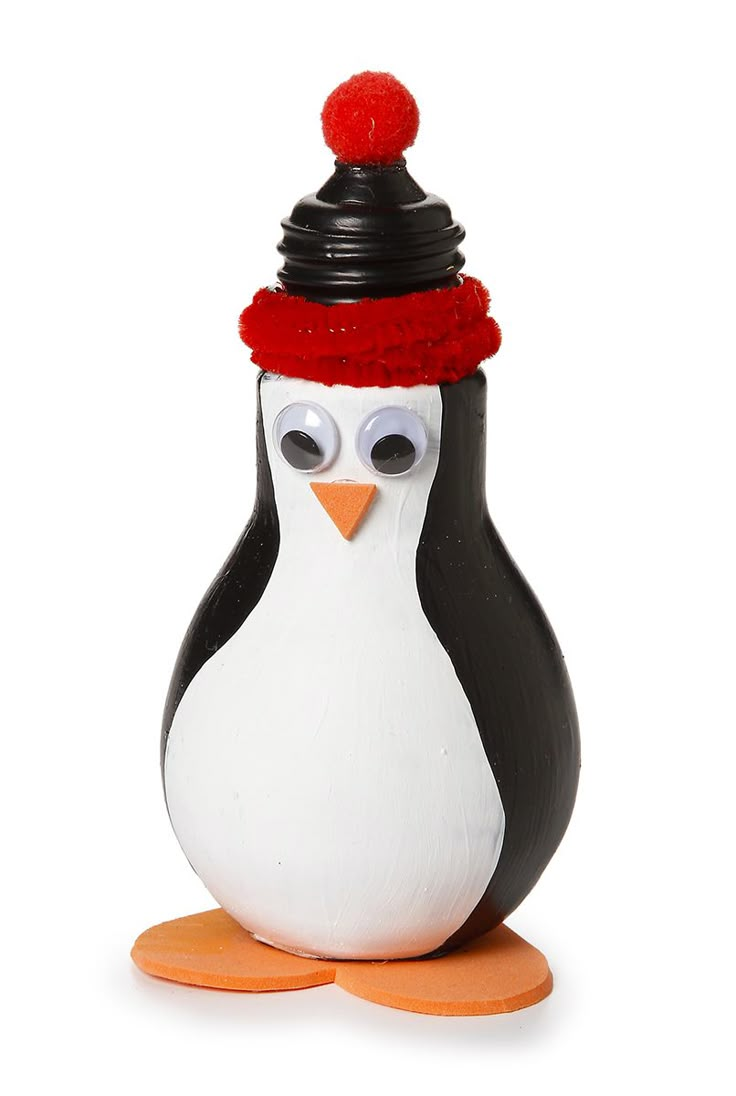 a penguin figurine with a red hat on it's head and eyes